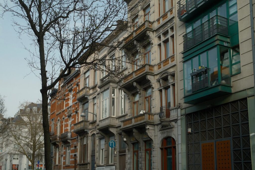 Row of old european apartment buildings with ornate balconies.