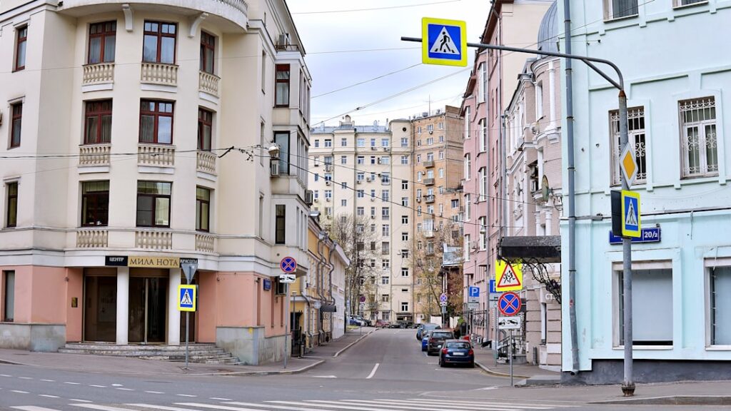 Street scene with apartment buildings and pedestrian crossing signs