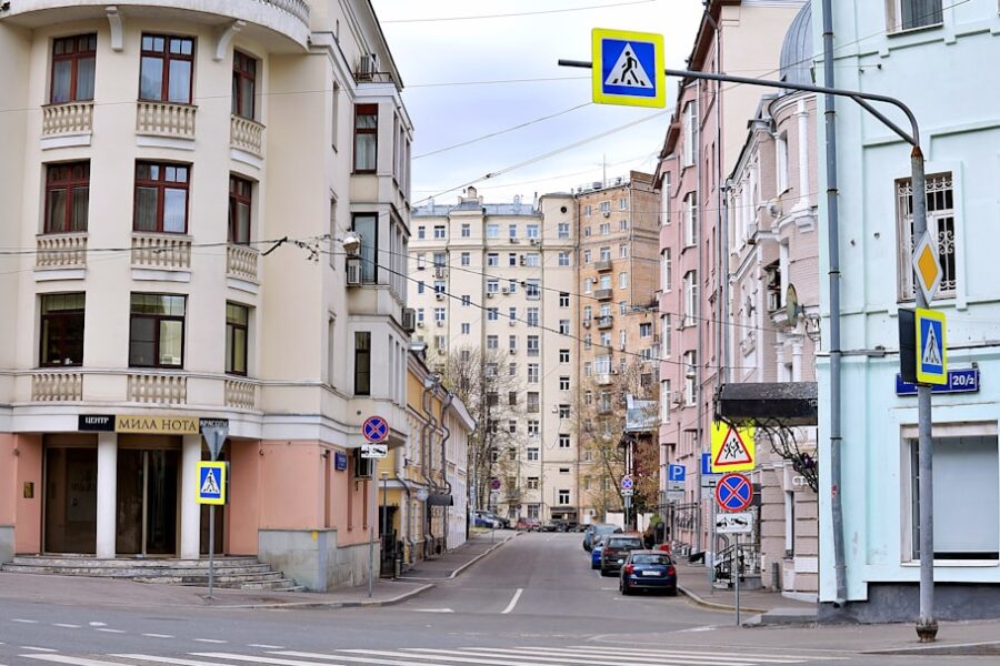 Street scene with apartment buildings and pedestrian crossing signs