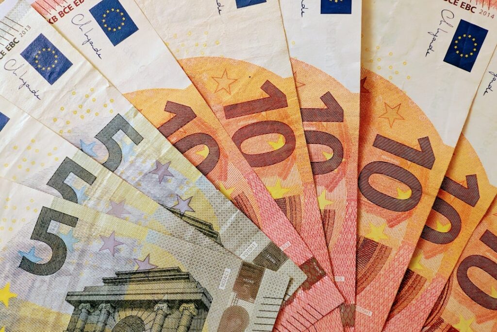 Euro banknotes fanned out, showing denominations.