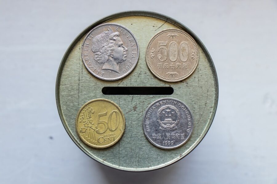 gold round coin on white surface